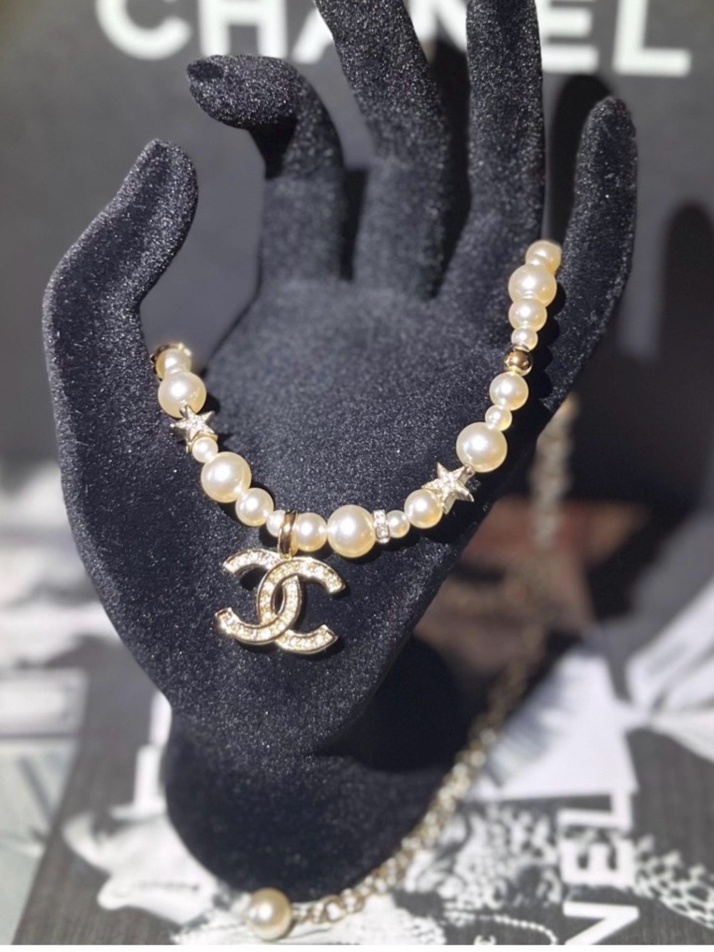 CHANEL Pearl Necklace with Gold CC Charm and Star Accents